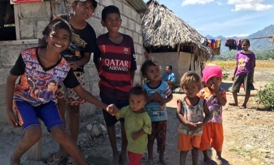 Change is coming to Oecusse, Timor-Leste. This family lives across the road from a half-constructed 56 room hotel. Photo: SBS